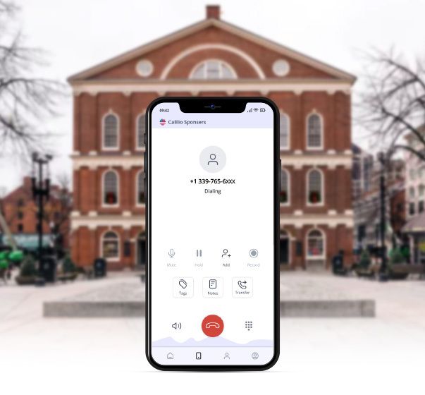  A mobile phone dialing 339 area code and Faneuil Hall in background